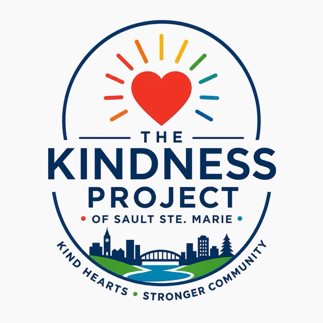 The Kindness Project of Sault Ste. Marie logo: a red heart with rainbow rays above the Sault Ste. Marie skyline